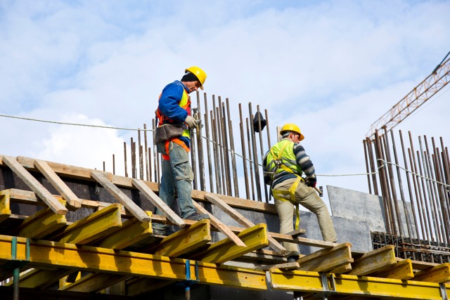 Construction workers on-site providing support and gathering data for as-built drawings