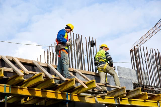 Construction workers on-site providing support and gathering data for as-built drawings